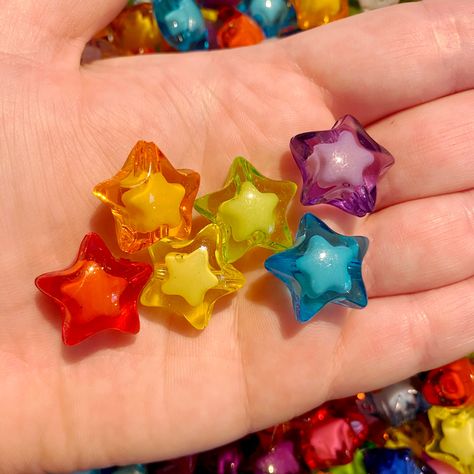 You will receive 36 of these 19mm plastic star beads.  These are perfect to DIY your own beaded necklace or bracelet.  Please note, these are sold in random sets of the colors shown. No color requests will be accepted. Sold as is. Must return in full for a refund or store credit. If you want to return, if all beads are not present, no refund or credit will be issued. Bulk discounts are available on our Brooklyn Charm website only.  B627 Paper Hearts Origami, Brooklyn Charm, Eyestrain Art, Diy Kandi, Star Beads, Pony Bead Patterns, Kandi Bracelets, Vintage Beads, Rainbow Beads