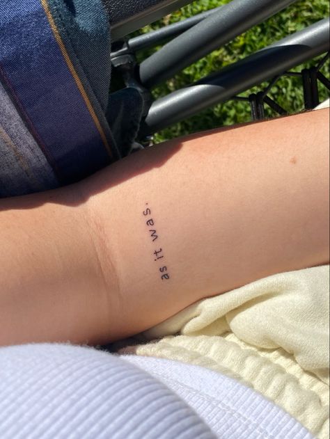 “as it was” tattoo in simple font on forearm As It Was Tattoo Ideas, Harry Styles Tattoos As It Was, Small Tattoos Harry Styles, Simple Harry Styles Tattoo, Harry Style Tattoo Ideas, As It Was Tattoo Harry Styles, Tiny Forearm Tattoo, Harry Styles Tatooes Idea, As It Was Tattoo