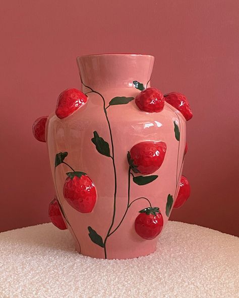 Our Pink Strawberry Vase is a charmingly rustic yet elegant addition to your home. This delightful strawberry vase effortlessly brings the beauty of nature indoors. Perfect as a sweet and thoughtful gift, it adds a touch of whimsy to any room it graces. Whether showcasing your favorite blooms or standing alone as a decorative piece, this vase embodies both simplicity and charm. Details & Care Dolomite Handmade and handpainted Size: H 30,3 x L 25,3 cm For our customers outside of Europe, please c Cottage Core Vase, Strawberry Wedding Decor, Ceramic Flower Vase Handmade, Fruit House Decor, Vase Clay Design, Cool Vases Ceramic, Red And Pink Decor, Strawberry Ceramics, Coil Vase Ceramics