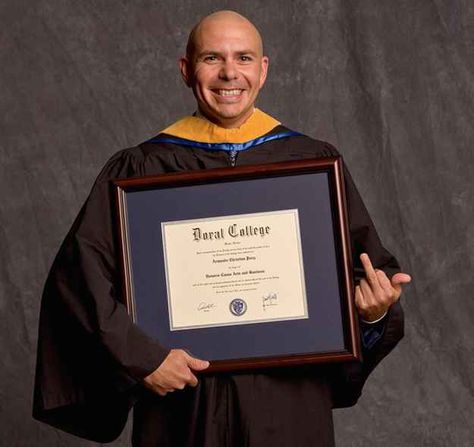 Pitbull holding an honorary degree from a non-accredited college is the happiest a human has ever been. | This Photo Of Pitbull Holding An Honorary Degree From A Non-Accredited College Is An Inspiration Pitbull