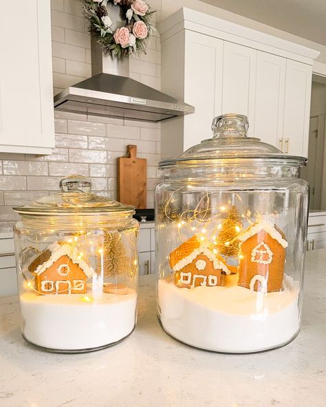 Glass House Christmas Decor, Glass Canister Christmas Decor Ideas, Glass Cabinet Christmas Decor, Christmas Jar Filler Ideas, Christmas Scene In A Jar, Jar Filler Ideas, Glass Gingerbread House, White Gingerbread House, Canister Decor