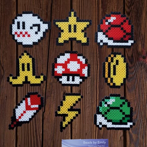 This listing is for one handmade Super Nintendo Mario Kart power up! Choose from plain finish, fridge magnet, or ornament with metal hook. Please contact me with any questions or to make a request. Thank you! Mario Kart Perler Beads, Perler Bead Home Decor, Mario Kart Pixel Art, Super Mario Perler Bead Patterns, Mario Perler Beads, Nintendo Crafts, Perler Mario, Nintendo Perler, Power Up