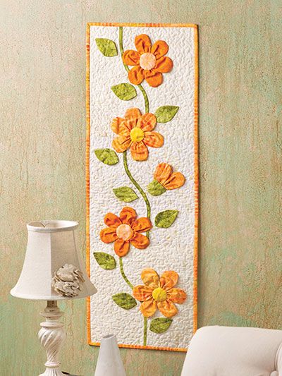 Peachy Keen Wall Hanging pattern and video from Annie's Creative Studio.  Click here to watch: https://www.anniescatalog.com/studio/detail.html?prod_id=144104 Bee Quilts, Applique Wall Hanging, Quilt Borders, Patchwork Table Runner, Small Wall Hangings, Spring Quilts, Flower Table, Flower Quilts, Quilted Table Toppers