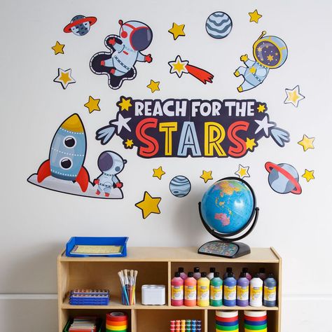 Blast off and spark curiosity and fun with this classroom wall statement piece that's truly out of this world! Featuring astronauts, a rocket, planets and stars, this is sure to be a perfect addition for classroom supplies that have a space or astronomy theme. Includes 24 cutouts on 5 sheets. Cardstock. (5 sheets per unit) Sheets, 24 1/2" x 16". © OTC  Space Wall Statement Piece Instructions Astronaut Classroom Theme, Astronomy Classroom, Space Classroom Theme, Wall Statement Piece, Space Theme Classroom, Wall Statement, Space Week, Space Classroom, Planets And Stars