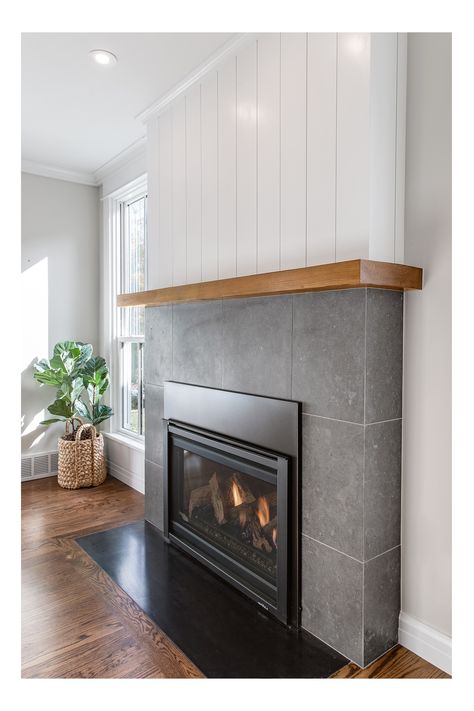 Big ideas made this small space grow with @eltonrconstruction. Leathered limestone tile, shiplap, solid fir mantle and a full flush inset blued steel hearth at this fireplace brings old and new into harmony. Fireplace With Low Hearth, Fireplace With Long Hearth, Flush Wall Fireplace Ideas, Flush Hearth Fireplace, Large Format Tile Fireplace Surround, Flush Fireplace Wall Ideas, Low Fireplace, Tile Around Fireplace, Mid Century Fireplace