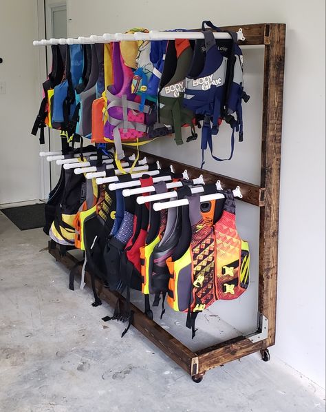 Kayak Gear Storage, Pool Float Storage Ideas For Garage, How To Store Life Jackets In Garage, Storing Life Jackets In Garage, Storing Life Jackets, Lake House Towel Storage, Life Jacket Organization, Kayak And Paddle Board Storage, Water Ski Storage Ideas