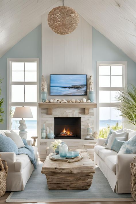 Coastal living room featuring an electric fireplace with a TV above and stylish wall storage, creating a harmonious decor. Fireplace On Window Wall, Coastal Stone Fireplace, Coastal Fireplace Ideas Beach Styles, Fireplace Beach House, Coastal Tv Wall, Beach House Fireplace Ideas, Living Room Electric Fireplace Ideas, Tv Wall Storage, Living Room Electric Fireplace