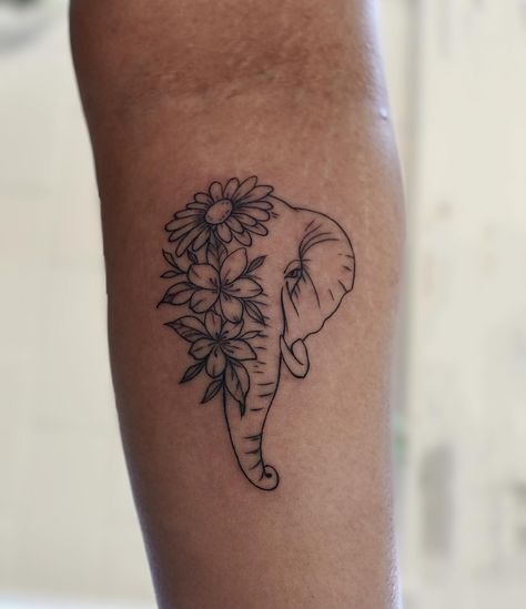 Grace and strength intertwine in this beautiful elephant tattoo adorned with delicate flowers. A symbol of wisdom, resilience, and the beauty that blooms from within By @carbonoidtattoos ‼️To book and appointment or consultation please visit our website, call or email ✏️🗒️ 💻 https://www.myinktattoo.ca/book 📲 +1 (416) 581-8888 📲 studio@myinktattoo.ca #tattoo #tattooer #tattooart #tattooideas #tattooartist #tattoo2me #firsttattoo #finelinetattoo #fineline #elephant #elephanttattoo #elephan... Cute Small Elephant Tattoo, Elephant Ears Tattoo, Elephant Flower Tattoo Design, Elegant Elephant Tattoos, Elephant Fine Line Tattoo, Cute Flower Tattoos Small, Elephant Flower Tattoo, Elephant Tattoos With Flowers, Christian Wrist Tattoos