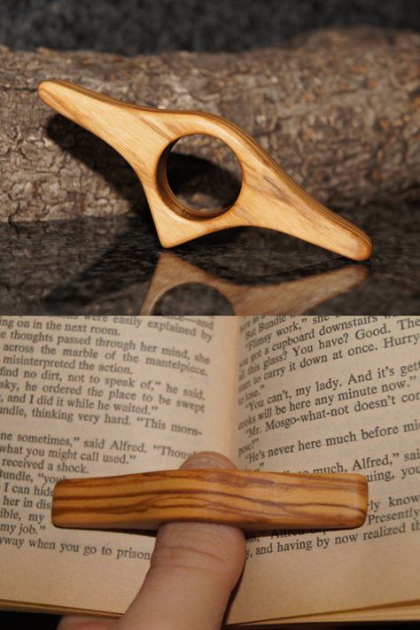 Read while comfortably holding a book open with one hand with a thumb ring book holder. Wooden Page Holder Pattern, Thumb Book Holder Diy, Book Ring Holder, Open Book Holder, Woodworking Gifts For Her, Wood Sculpture Ideas Simple, Book Thumb Holder, Ceramic Book Holder, Book Holder Ideas