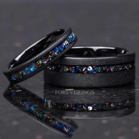 ►Material: Tungsten Carbide, Meteorite, and Opal ►Color: Black ►Comfort Fit ►His Band Width: 8mm ►Her Band Width: 4mm ►Fit is true to size for Her band (4mm). ►Fit is true to size for His Band (8mm). ►This hand-crafted tungsten ring features a stunning inlay of galaxy opal and meteorite flakes. The meteorite flakes are sourced from genuine Gibeon meteorite. The opal showcases a dazzling array of iridescent colors in sunlight. A beautiful alternative for a wedding band, this ring will stand out a Galaxy Wedding Dress, Gay Engagement Rings, Meteorite Rings, Black Titanium Ring, Gibeon Meteorite, Stunning Diamond Rings, Couples Ring, Matching Wedding Rings, Black Tungsten Rings