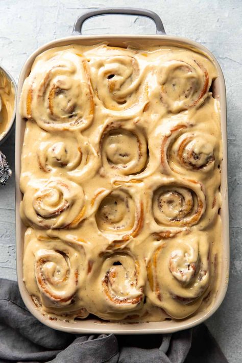 You will love these warm pumpkin cream cheese cinnamon rolls! They are perfect for fall. They boast swirls of fluffy, soft cinnamon dough with luscious, pumpkin cream cheese frosting on top. Ambitious Kitchen Cinnamon Rolls, Pumpkin Cheesecake Cinnamon Rolls, Fall Cinnamon Rolls Aesthetic, Pumpkin Sweet Rolls, Fancy Cinnamon Rolls, Cream Cheese Frosting For Cinnamon Rolls, Pumpkin Cinnamon Rolls Easy, Fall Cinnamon Rolls, Pumpkin Roulade