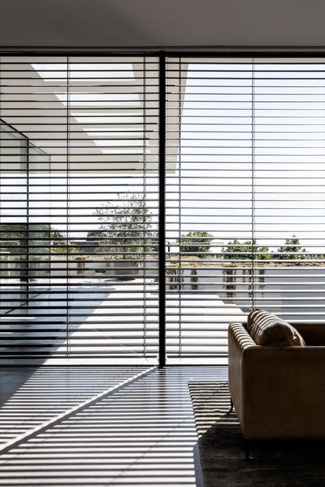 Also installed were external motorised venetian blinds. These not only allow the inhabitants’ control over light and privacy but they also cast striking shadows across the room, layering consistent lines over honed grey limestone floors. #venetianblinds #livingroom #dreamhouse #beautifulinteriors #amazinghome #modernhome #interiordesign Materials Architecture, Limestone Floors, Luxury Blinds, Modern Blinds, Hampton House, Abstract Forms, Wide Windows, The Local Project, Venetian Blinds