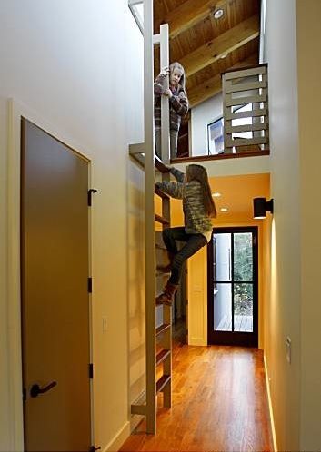 Berkeley-based designer Gustave Carlson used reclaimed teak flooring, custom powder-coated aluminum windows and doors from Bonelli Windows & Doors in S Attic Game Room, Wall Ladder, Attic Wardrobe, Slanted Walls, Attic Lighting, Attic Playroom, Aluminium Windows And Doors, Loft Stairs, Small Attic