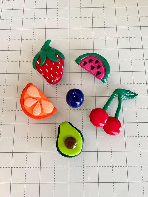 Brighten up your kitchen, office, or dorm room with these adorable handmade clay magnets! Each magnet is delicately hand-sculpted from polymer clay, baked to perfection, and finished with a glossy glaze. The clay is securely attached to sturdy magnets (0.5" / 12.7 mm diameter) with superglue gel. The clay strawberry and cherries are both approximately 2" (L) x 1.5" (W).  The clay orange and watermelon are both approximately 1.5" (L) x 1" (W). The clay blueberry is approximately 0.75" (L) x 0.75" Fruit Fridge Magnets, Cherry Clay Magnet, How To Clay Art, Air Dry Clay Projects Magnets, Clay Fish Magnet, Fruit Clay Magnets, Diy Fridge Magnets Creative, Polymer Clay Watermelon, Art Things To Sell