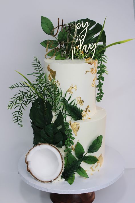 All white cake, green and gold details Leaf Birthday Theme, Coconut Theme Cake, Coconut Themed Party, Birthday Cake Tropical Theme, Plant Theme Cake Ideas, Greenery Birthday Cake, Birthday Cake Plants Theme, Hawaiian Party Table Decorations, Modern Tropical Wedding Cake