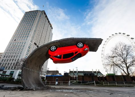 Car upended on tarmac wave in Alex Chinneck installation. Vauxhall Motors, Hanging Upside Down, Public Sculpture, Installation Design, London Eye, British Artist, French Artists, Public Art, Car Art