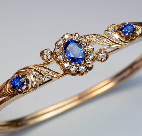 Antique Victorian Era Sapphire Diamond Gold Bracelet, Moscow, circa 1890. A 14K gold bangle bracelet is centered with a sparkling blue sapphire surrounded by old rose cut diamonds, flanked by two diamond-set scrolls and two smaller sapphires. Diamond Gold Bracelet, 14k Gold Bangle Bracelet, Diamond Carat Size, Bangle Diamond, Shiny Bracelets, Diamond Bracelet Design, Antique Engagement Ring, Bracelets Design, Gold Jewelry Sets