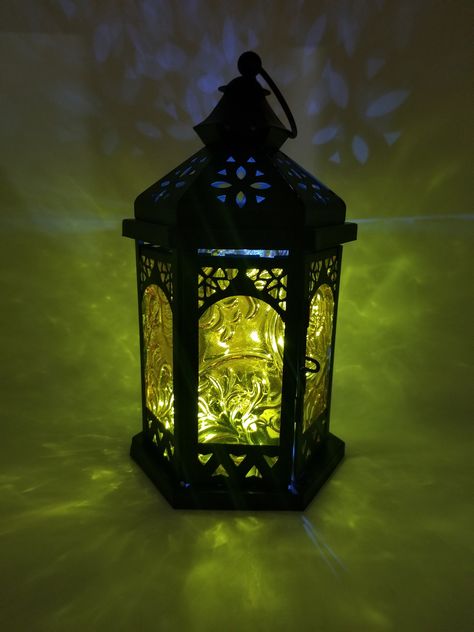 "Sunny Gardens Custom Handmade Glass Lantern | Home Outdoor Deck Themed Decor | LEDs | Candleholder | Yellow Black Centerpiece | Gift Idea Dimensions: Width: 5\" Sunny Gardens Glass Lantern is stunningly beautiful with custom handmade glass panes in transparent Iridescent yellow and black metal lantern. It comes with removable battery powered LED lights. This unique handmade lantern is the perfect piece to brighten up any space or as a gift for any occasion. Handmade in Richmond, VA" Lanterns With Candles, Enchanted Lantern, Glass Lantern Centerpieces, Diy Lantern Lights, Cute Lantern, Lantern Aesthetic, Glass Bowl Centerpieces, Table Lantern, Black Centerpieces