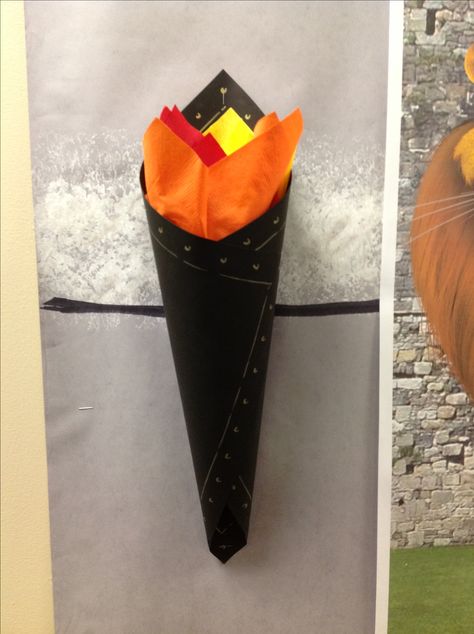 VBS Kingdom Rock. Wall torchiere made from 12"x12" paper wrapped around a solo cup. Stuffed with paper napkins and detailed with paint pen. Castle Classroom Door Decorating Ideas, Castle Quest Boosterthon, Castle Door Decorations Classroom, Vbs Kingdom Theme, Kingdom Rock Vbs, Mighty Fortress Vbs, Medieval Torch, Castle Decorations, Castle Classroom