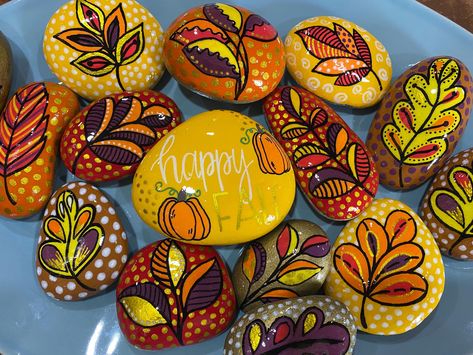 These fall leaves rocks are hand-painted and feature bright fall colors! Perfect to add to your fall decor collection or to offer on a Thanksgiving table!  These measure approximately 3in. x 3in and are pocket-sized. These are one-of-a-kind,hand-painted items, so the size and shape of rocks may vary. They are beautiful when paired with the "Happy Fall" decor rock featured here: https://www.etsy.com/listing/1784025754/happy-fall-painted-rock-fall-decor-rock?click_key=e653bcc9a85092179e0f4343b6847 Fall Themed Rock Painting, Painted Rocks For Fall, Autumn Painted Rocks, Fall Painted Rocks Ideas, Thanksgiving Painted Rocks, Fall Painted Rocks, Thanksgiving Paintings, Fall Rock Painting Ideas, Things To Paint On Rocks