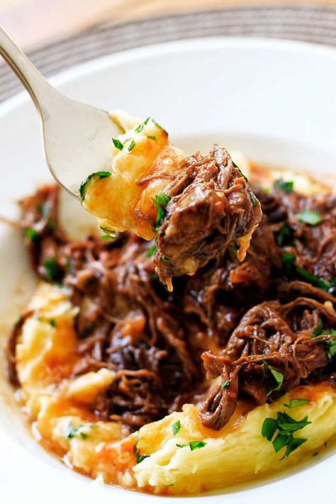 Tender short ribs in a tomato red wine sauce with Parmesan mashed potatoes - this hearty Short Rib Ragu is worth the time! Serve it over mashed potatoes, egg noodles, rice, or pasta for the best comfort food dinner ever. Slow Cook Short Ribs, Short Rib Ragu, Cheap Meals For Two, Cooking Short Ribs, Parmesan Mashed Potatoes, Recipes Winter, Ragu Recipe, Winter Meals, Short Ribs Recipe