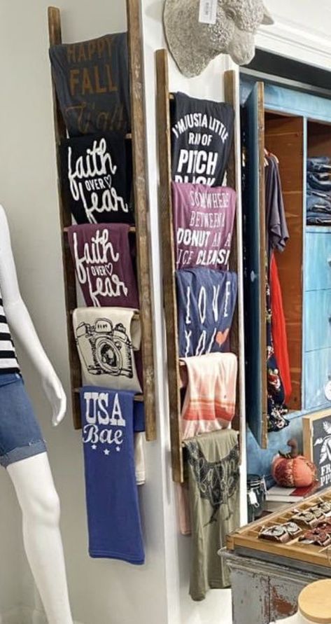 Rustic T Shirt Display, How To Display Leggings In A Boutique, Ways To Display Shirts For Sale, Tee Shirt Display Ideas Retail, Cheap Display Ideas, How To Display Tshirts To Sell, Diy Storefront Display, Vendor Booth Display Ideas Shirts, Ladder Tshirt Display