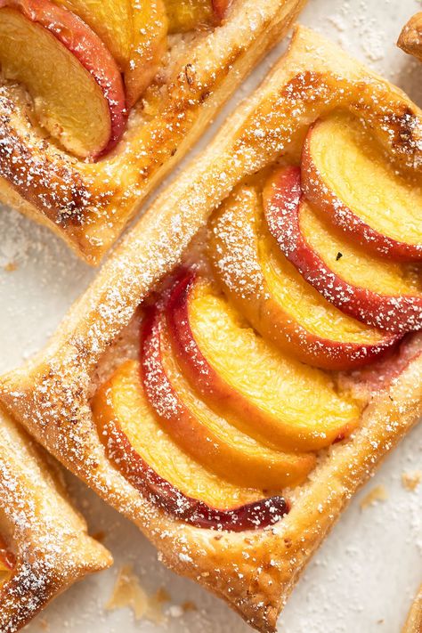 These peach puff pastry tarts are crispy, flaky, and full of flavor. With just five ingredients, they’re quick to make and ready to serve in about 30 minutes. Peach Recipes Puff Pastry, Peach Phyllo Dough Recipes, Fresh Peach Puff Pastry Recipes, Puff Pastry And Peaches, Peach Tart Puff Pastry, Puff Pastry Peach Recipes, Peach Pastry Recipes, Peaches Puff Pastry, Peach Puff Pastry Desserts