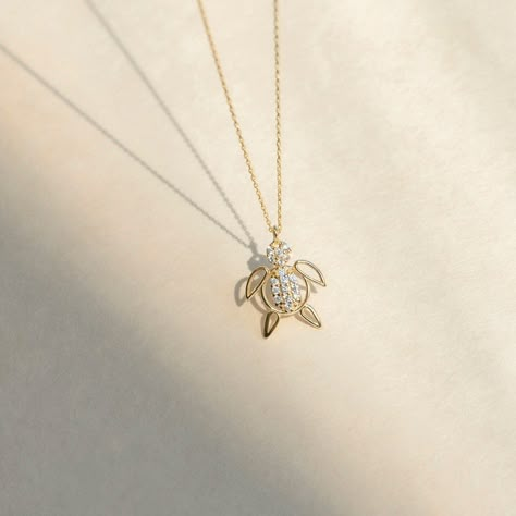 "1- D E S C R I P T I O N Embrace nature's beauty with this 14K Solid Gold CZ Turtle Necklace for Women, featuring a charming turtle pendant adorned with sparkling cubic zirconia stones, adding a touch of elegance and charm to your style. 2- P R O D U C T ∙ F E A T U R E S * Gold material: 14K solid gold * Gold color options: Yellow gold, Rose gold, White gold * Stone: Cubic Zirconia * Choice of chain length: 14\", 16\", 18\", 20\", Pendant Only  * Dimensions:    Pendant Height: 12 mm / 0.47 in Necklace Pendant Design, Cute Pendants, Nature Friendly, Nature Necklace, Solid Gold Necklace, Turtle Necklace, Turtle Pendant, Meaningful Jewelry, 14k Gold Necklace