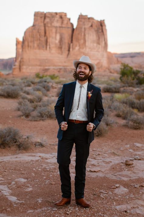 bolo tie, desert wedding, cowboy boots, moab elopement, blue suit, groom style, cowboy hat Vegas Wedding Suit, Suit With Cowboy Boots, Cowboy Wedding Attire, Wedding Outfits For Men, Boho Groom, Wedding Suit Men, Cowboy Groom, Cowboy Suit, Casual Groom Attire