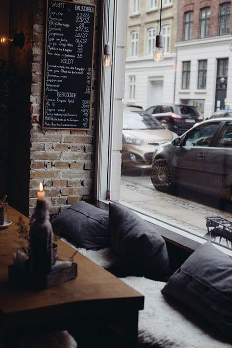 The cozy, woodsy nook at La Esquina in Copenhagen. | 31 Coffeeshops And Cafés You Wish You Lived In Cozy Cafe Design, Spanish Cafe, City Cafe, Window Seating, Cafe Lounge, Denmark Copenhagen, Cute Coffee Shop, Cozy Coffee Shop, Design Café