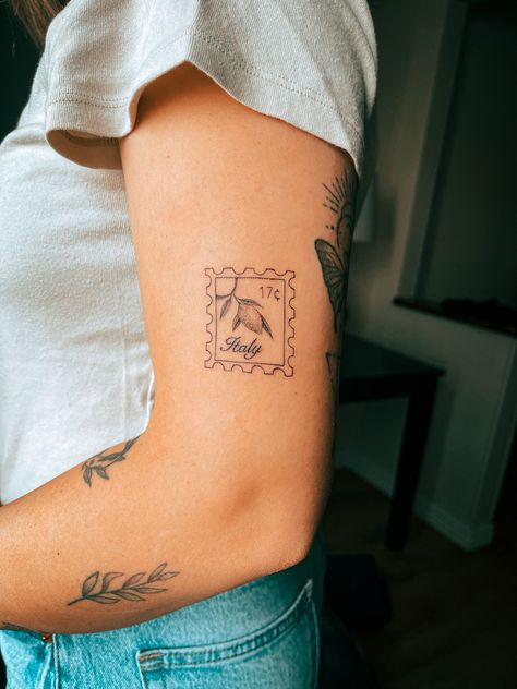 Fine line detailed Italy lemon stamp tattoo on arm Lemon Stamp, Cleveland Tattoo, Italy Stamp, Italy Tattoo, Stick And Poke Tattoo, Stamp Tattoo, Flash Designs, Small Girly Tattoos, Hibiscus Tattoo