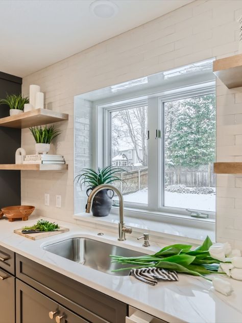 Go to the link to see more see this kitchen reno. This kitchen window above the sink has a ledge with a slab of quarts and surrounded by tile. Floating shelves on both sides of the window. Kitchen Window With Ledge, Kitchen Window Ledge Over Sink, Kitchen Window With Backsplash, Floating Shelves Next To Kitchen Window, Tile Around Kitchen Window No Trim, Tile Around Kitchen Window Over Sink Backsplash, Kitchen Window With Shelves, Small Kitchen Window Over Sink Open Shelves, Kitchen Wall Window