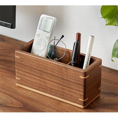 Marketing Strategy: Are you troubled by a cluttered office desk? Say goodbye to chaos with a multi-functional wooden pen holder that frees up space and enhances organization. Crafted from natural wood, finely polished, and durable, it brings a touch of elegance and order to your workspace. | Ivy Bronx Desktop Storage Box, Office Organizer, Miscellaneous Storage Box Brown 3.9 x 7.87 x 3.14 in, Solid Wood | C110738308_2012347231 | Wayfair Canada Cluttered Office, Wood Charging Station, Wood Pen Holder, Wooden Pen Holder, Wooden Ideas, Wooden Desk Organizer, Wood Office, Office Organizer, Hobby Ideas