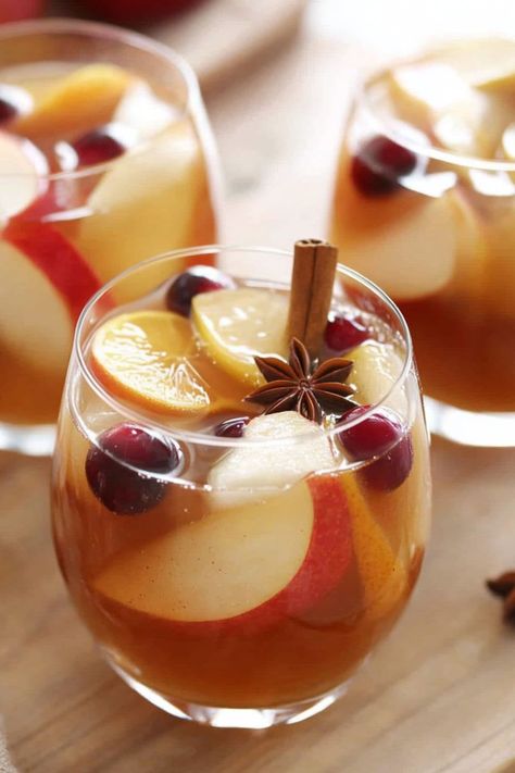 This apple cider sangria is the perfect fall tipple! With hints of nutmeg, orange, pear, apple, and cinnamon, it's impossible to resist. Cider Sangria, Apple Cider Sangria, Apple And Cinnamon, Spiced Apple Cider, Happy Hour Drinks, Apple Varieties, Red Sangria, Sweet Wine, Sangria Recipes