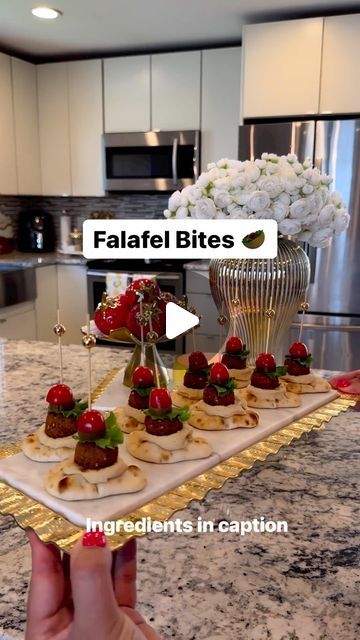 Reina G. Slim on Instagram: "On Fridays we make Falafel bites🤤🥙 What you will need 👇🏻  This is one of our favorite appetizer/snack around here. It’s the perfect appetizer for any occasion. Not only it’s so fun/easy to put together but soooo delicious and a crowd pleaser for sure! I’ve also made it with cucumber slices instead of the naan, sooo good! Try it out for your next gathering and thank me later😉  Ingredinets:  ▫️Mini Naan bread @stonefirenaan  ▫️Roasted garlic hummus or original ( I used roasted garlic)  ▫️Cherry tomatoes ( halved) ▫️Green leaf lettuce ( torn) ▫️Pickles ( sliced) ▫️Mini falafel balls ( Check Middle Eastern grocery stores or @traderjoes  ▫️Bamboo sticks   Now, it’s time to assemble. Scoop about 1 tsp hummus and place it on naan bread then using a bamboo stick s Mini Naan Appetizer, Mini Naan Bread Ideas Appetizers, Mini Naan Bread Appetizers, Naan Bread Appetizers, Naan Appetizers, Crowd Pleaser Appetizers, Mini Naan, Make Falafel, Falafel Balls