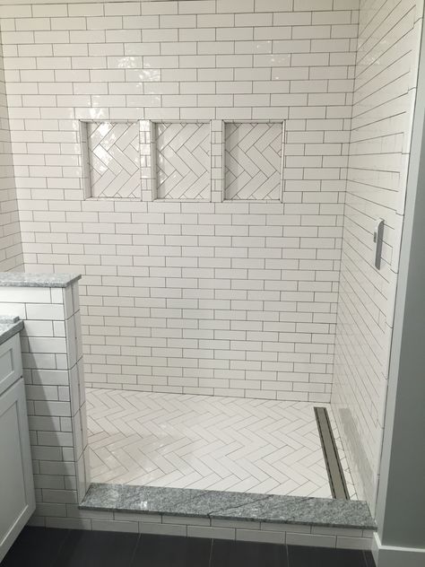 White Herringbone Shower Tile Floor, Herringbone Tile Shower Wall, White Herringbone Shower, Black Herringbone Tile Bathroom, Herringbone Shower Floor, Vertical Shower Tile, Airbnb Bathroom, Small Wet Room, Herringbone Tile Bathroom