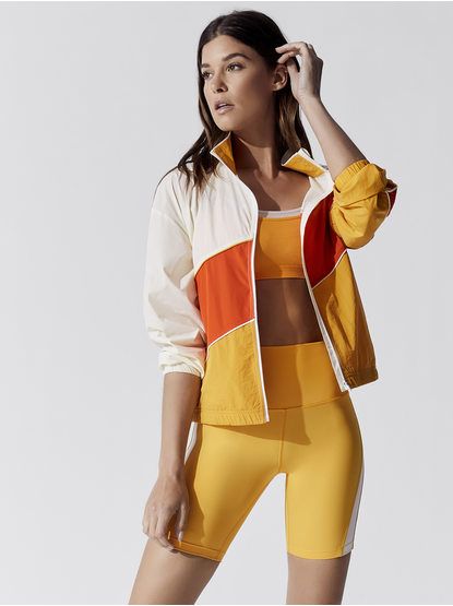 New Women's Active and Ready to Wear | Carbon38 Bright Sporty Outfits, Orange Athleisure, Activewear Editorial, Stretch Clothes, Nike Sportswear Women, Model Pose, Yellow Jacket, Activewear Brands, Activewear Fashion