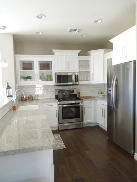 Next house...white cabinets, white backsplash, gray granite and wood tile floors.  Love this remodel. Builder Grade Kitchen, Light Granite, Kabinet Dapur, Herringbone Backsplash, Dark Floors, Wood Tile Floors, Future Kitchen, Decor Ikea, White Cabinetry