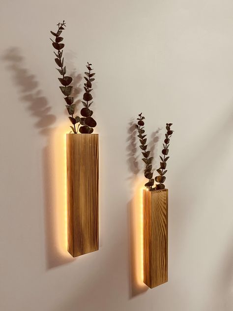 PRICES MAY VARY. BEAUTIFUL LED WALL PLANTER DECORATION – These slim wood wall planters with LED lights and 4 faux eucalyptus stems , and a perfect complement for any wall in your home or office. It will add personality to your gallery wall, bedroom, over the bed, living room, dining room, kitchen, bathroom, indoor patio, bedroom, entry way, dorm or office BOHO DECOR – Each of our wall lights Behind the rustic wooden vase that helps highlight that artificial plants and gorgeous LED lighting. Hang Kitchen Hanging Decor, Decoration Corner Living Room, Wooden Wall Decor Living Room Interiors, Lader Decoration Living Room, Small Apartment Living Room Wall Decor, Hanging Wood Decor, Aesthetic Wooden Room Decor, Southwestern Shelf Decor, Simple Hallway Decor