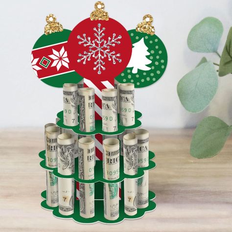 Ornaments Cash Cake includes 1 DIY money cake holder kit that can hold up to 20 rolled bills and adhesive dots. The X-mas money cake comes with a unique ornament-shape centerpiece size 4.5 inches wide by 6.5 inches tall, base and center layers size 3.75 inches in diameter, and top layer size 2.5 inches in diameter. Circle slot cut-outs measure 0.5 inches in diameter. Unique Gift: Perfect for a Holiday and Christmas Party, the Ornaments cash cake stand is a trendy and creative way to gift money. Cash Cake, Centerpiece Stand, Birthday Candle Card, Cash Holder, Elf Decorations, Graduation Party Diy, Money Cake, Gift Money, Colorful Birthday Party