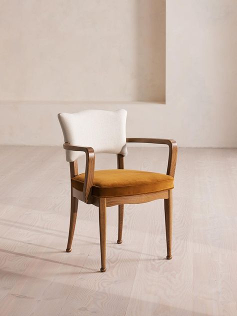 Carved from mid-toned beech wood, this dining chair is finished in mustard velvet upholstery. Characterized by a playful, wavy backrest and bobbin detailing at the feet, the Charleston dining chair is carved in Italy from beech wood. There are also armless, co-ordinating chairs available to pair with it. Soho Home Charleston Dining Chair With Arms, Velvet in Mustard, Us Vintage Kitchen Table Chairs, Dining Arm Chairs Upholstered, Unique Dining Chairs, Vintage Chairs Makeover, Mustard Chair, Dining Chairs With Arms, Sideboard Media Console, Dining Chair With Arms, Reupholster Chair Dining