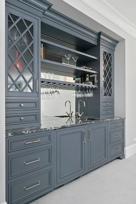 Gray wet bar cabinets painted in Benjamin Moore Ashland Slate are fitted with nickel pulls and a gray quartzite countertop holding a small square sink with a polished nickel gooseneck faucet in front of a mirrored backsplash finished with built in shelves flanked by gray lattice glass front cabinets. Wet Bar Cabinets, Bar Nook, Cart Bar, Bar Outdoor, Bar Basement, Quartzite Countertops, Gray Cabinets, Design Bar, Home Bar Designs