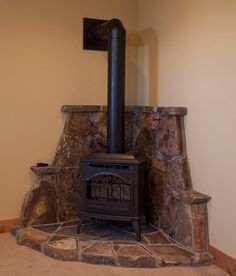 Corner Wood Stove Ideas | few elements (like wall color ... Corner Hearth Ideas For Wood Stove, Buck Stove Fireplace Ideas, Indoor Wood Burning Stove, Corner Hearth, Wood Stove Decor, Wood Burning Stove Corner, Corner Wood Stove, Wood Stove Surround, Stove Hearth