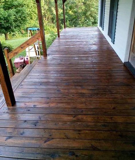 We love this stain that we used on our covered front porch, which is the length of our home. However, we are going to use the same on our side porch and back deck, which are not covered. It is absolutely beautiful! Dark Stain Porch, Primitive Exterior House, Patio Stain Colors, Porch Stain Colors Wood, Wood Deck Colors, Porch Stain, Deck Stains, Porch Walkway, Dark Blue Houses