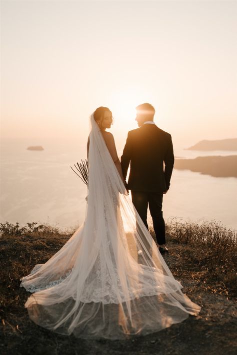 Greece Wedding Photoshoot, Wedding Photo Sunset, Wedding Photos With Movement, Santorini Gem Wedding, Romantic Wedding Photos Aesthetic, Sitting Wedding Poses, Wedding Photo Ideas Bride And Groom Outdoor, Landscape Wedding Photography, Bride And Groom Beach Wedding Photos