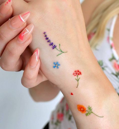 Many colorful small flowers tattoos on the hand Colorful Tattoos For Women Small, Colorful Tatoos Woman, Tiny Color Tattoos, Small Color Tattoo, Wrist Flower Tattoo, Symbole Tattoo, Small Colorful Tattoos, Tiny Flower Tattoos, Simple Flower Tattoo