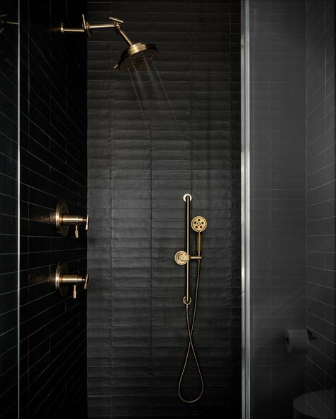 Stallings Studio set a moody ambiance with the Litze® Bath Collection in this audacious black and gold shower. Photography: AIR Design Photography Dramatic Bathroom, Black Tile Shower Ideas, Black Bathroom Fixtures, Glamorous Bathroom, Gold Bathroom Decor, Black And Gold Bathroom, Gold Faucet, Bathroom Accent Wall, Dark Tile