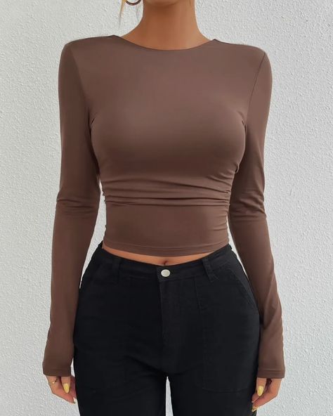 NEW - Sculpt Backless Long Sleeve Crop Under $30 Sleek, sultry, and effortlessly chic—the Sculpt Backless Long Sleeve Crop is the essential statement piece your wardrobe needs. Featuring a body-hugging fit with long sleeves and a striking open-back design, this top is perfect for day-to-night transitions. The rich brown color adds a warm, earthy tone to your outfit, while the upcoming black version will bring a sleek, versatile option to your collection. Pair it with high-waisted pants... Outfits With Brown Top, Brown Shirt, Backless Top, Long Sleeved Top, Brown Top, Long Sleeve Knit Tops, Solid Clothes, 4 20, Long Sleeve Casual