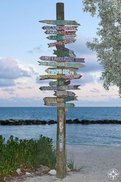 The iconic destination sign post pointing from Key West all over the world - at dusk on the beach in Fort Taylor Park. #HappierPlace #travel #travelinspiration Destination Signs, Key West Travel, Tiki Signs, Travel Key West, Zachary Taylor, Florida State Parks, Backyard Games, Key West Florida, Sign Post