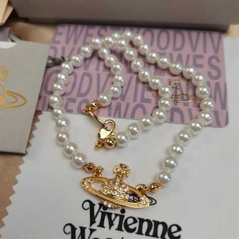 "Brand New Vivienne Westwood Gold Orb Pearl Choker Necklace Button Necklace (Brand New) Brand New, Never Worn, Nwot 100% Authentic Comes With Gift Box, Gift Bag, And Dust Bag,Brand Cards,Instruction Manual,Jewelt Cloth. Full Packing As Inculded. Necklace Packed In Secure Packaging For Transit The Length Was : 16.5'' Welcome To Share Vivienne Westwood Jewellery, Saturn Necklace, Jewelry Sets Handmade, Necklace Outfit, Big Necklace, Button Necklace, Square Necklace, Silver Pearl Necklace, Gold Pearl Necklace